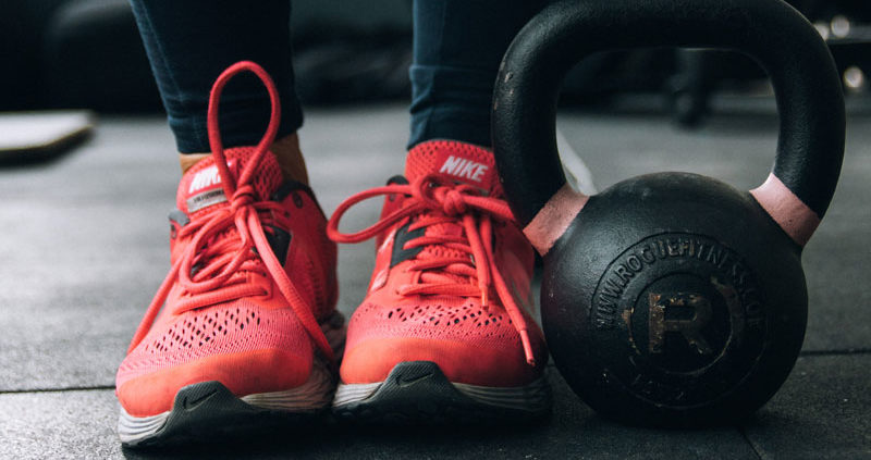 Tennis shoes and a kettle bell