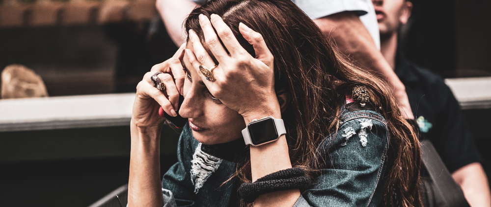 A woman expressing anxiety on the phone