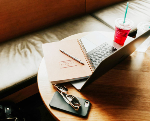 laptop sitting on a table in a coffee shop