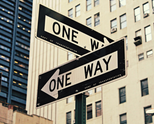 two signs displaying "one way"