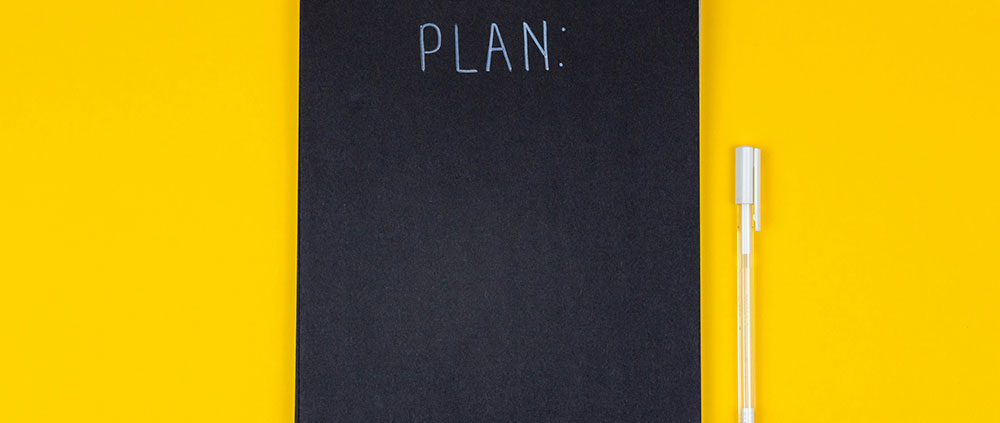 notebook displaying the words "plan"