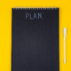 notebook displaying the words "plan"