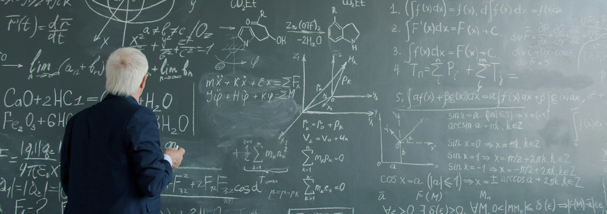 man standing in front of a busy chalkboard