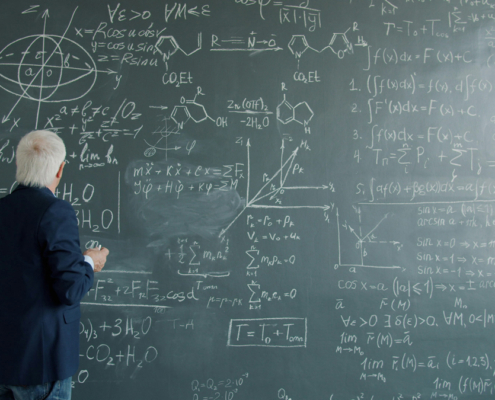 man standing in front of a busy chalkboard