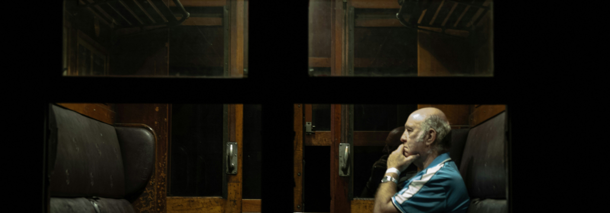 man sitting along in a train car