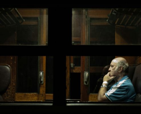 man sitting along in a train car